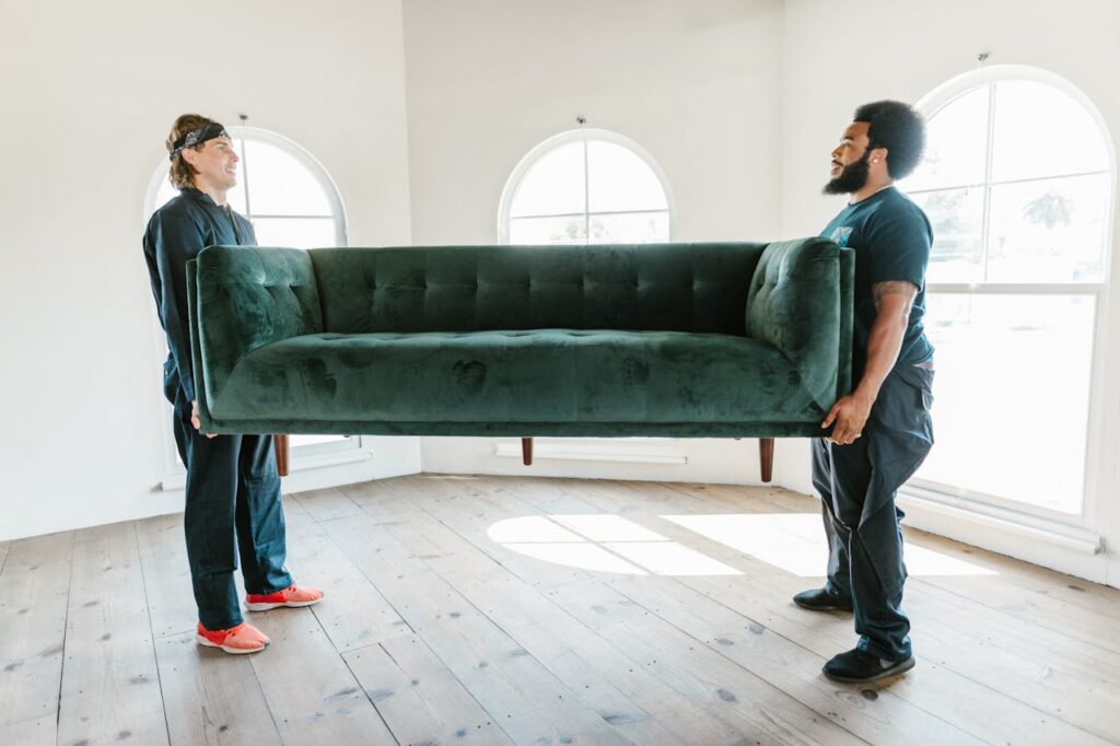 Close-Up Shot of Men Carrying a Couch Experienced furniture movers